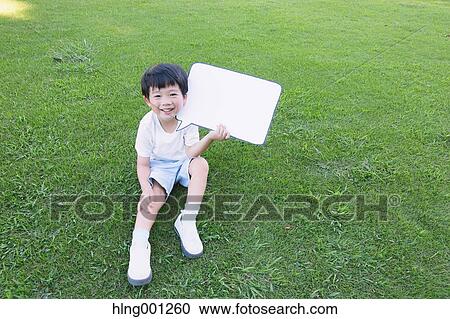 Japanese young boy with whiteboard in a city park View Large Photo Image Stock Image - Japanese young boy with whiteboard in a city park. Fotosearch