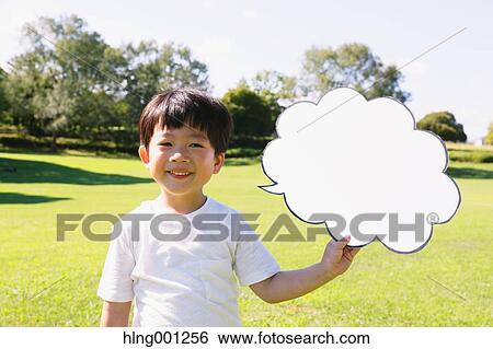 Stock Photograph - Japanese young boy with whiteboard in a city park. Fotosearch