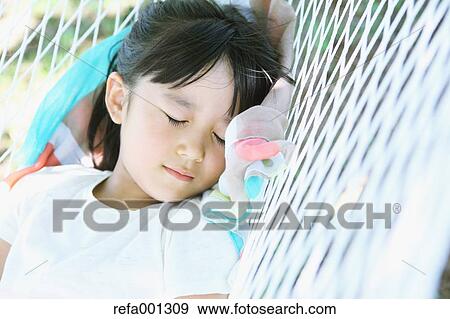Japanese young girl on hammock in a city park View Large Photo Image Stock Photo - Japanese young girl on hammock in a city park. Fotosearch