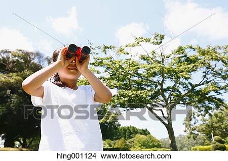 Japanese young girl with binoculars in a city park View Large Photo Image Picture - Japanese young girl with binoculars in a city park. Fotosearch