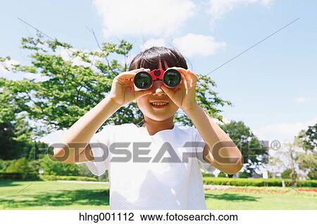 Japanese young girl with binoculars in a city park View Large Photo Image Stock Image - Japanese young girl with binoculars in a city park. Fotosearch