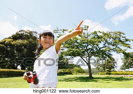 Japanese young girl with binoculars in a city park View Large Photo Image Stock Image - Japanese young girl with binoculars in a city park. Fotosearch