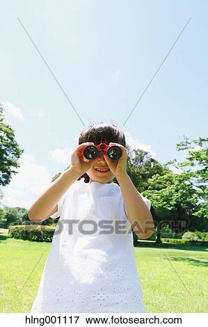 Japanese young girl with binoculars in a city park View Large Photo Image Stock Photo - Japanese young girl with binoculars in a city park. Fotosearch