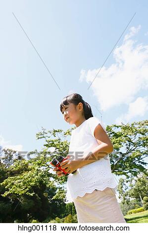 Japanese young girl with binoculars in a city park View Large Photo Image Stock Photo - Japanese young girl with binoculars in a city park. Fotosearch