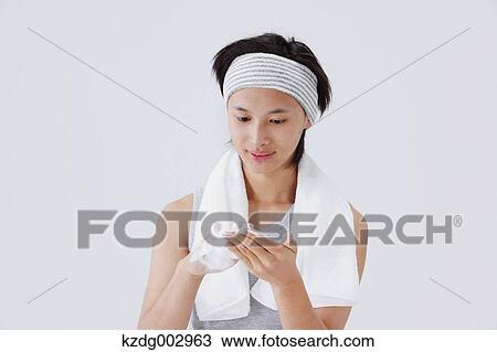 Stock Image - Portrait of young man doing skin care. Fotosearch