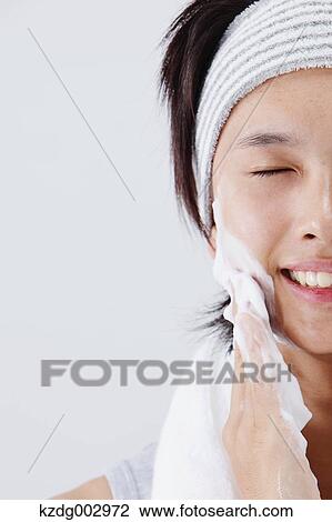 Portrait of young man doing skin care View Large Photo Image Stock Image - Portrait of young man doing skin care. Fotosearch