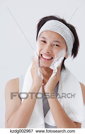 Stock Photo - Portrait of young man doing skin care. Fotosearch