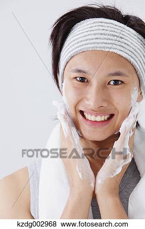 Portrait of young man doing skin care View Large Photo Image Stock Photo - Portrait of young man doing skin care. Fotosearch