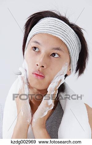 Stock Photo - Portrait of young man doing skin care. Fotosearch