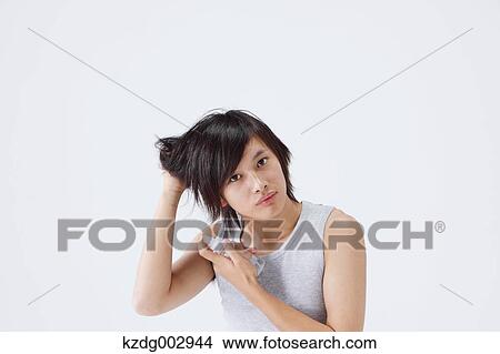 Portrait of young man using moisture View Large Photo Image Picture - Portrait of young man using moisture. Fotosearch