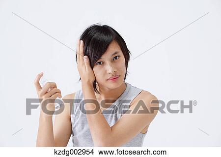 Picture - Portrait of young man using moisture. Fotosearch