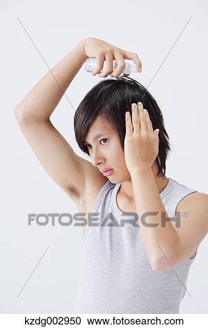 Stock Image - Portrait of young man using moisture. Fotosearch