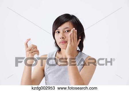 Stock Image - Portrait of young man using moisture. Fotosearch