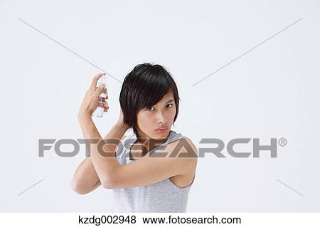 Portrait of young man using moisture View Large Photo Image Stock Photo - Portrait of young man using moisture. Fotosearch