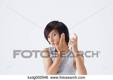 Stock Photograph - Portrait of young man using moisture. Fotosearch