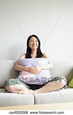 Stock Photo - Woman relaxing on the sofa. Fotosearch