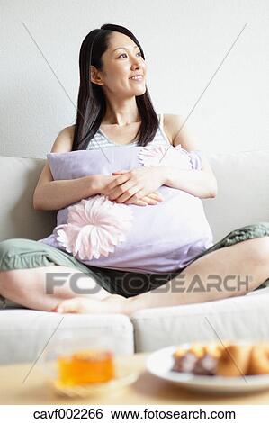 Stock Photograph - Woman relaxing on the sofa. Fotosearch