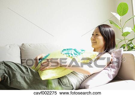 Stock Photography - Woman relaxing on the sofa. Fotosearch