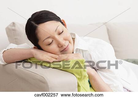Stock Photo - Woman sleeping on the sofa. Fotosearch
