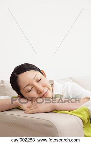 Stock Photo - Woman sleeping on the sofa. Fotosearch