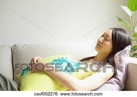 Stock Photograph - Woman sleeping on the sofa. Fotosearch