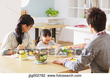 Young adult couple and their daughter having breakfast in their dining room View Large Photo Image Stock Image - Young adult couple and their daughter having breakfast in their dining room. Fotosearch
