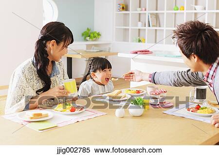 Young adult couple and their daughter having breakfast in their dining room View Large Photo Image Stock Photography - Young adult couple and their daughter having breakfast in their dining room. Fotosearch
