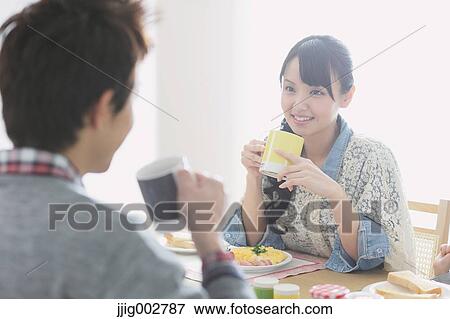Young adult couple having breakfast in their dining room View Large Photo Image Stock Photo - Young adult couple having breakfast in their dining room. Fotosearch