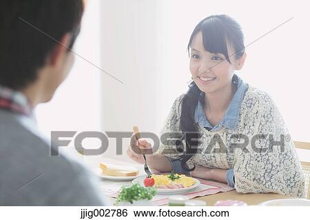 Young adult couple having breakfast in their dining room View Large Photo Image Stock Photograph - Young adult couple having breakfast in their dining room. Fotosearch