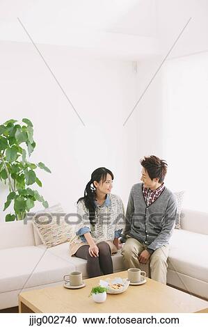 Young adult couple relaxing on the sofa View Large Photo Image Stock Image - Young adult couple relaxing on the sofa. Fotosearch
