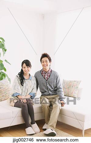 Young adult couple relaxing on the sofa View Large Photo Image Stock Photograph - Young adult couple relaxing on the sofa. Fotosearch