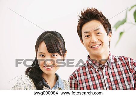 Young adult couple smiling View Large Photo Image Picture - Young adult couple smiling. Fotosearch