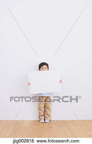 Young boy leaning against a white wall with whiteboard View Large Photo Image Stock Photo - Young boy leaning against a white wall with whiteboard. Fotosearch