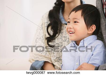 Young boy looking away and smiling View Large Photo Image Stock Photo - Young boy looking away and smiling. Fotosearch