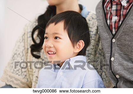 Young boy looking away and smiling View Large Photo Image Stock Photograph - Young boy looking away and smiling. Fotosearch