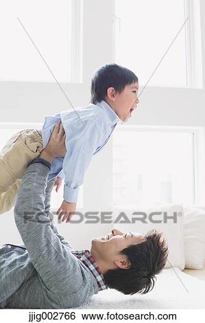 Young boy playing with his father View Large Photo Image Stock Photograph - Young boy playing with his father. Fotosearch