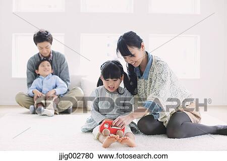 Young family laying on the floor View Large Photo Image Stock Image - Young family laying on the floor. Fotosearch