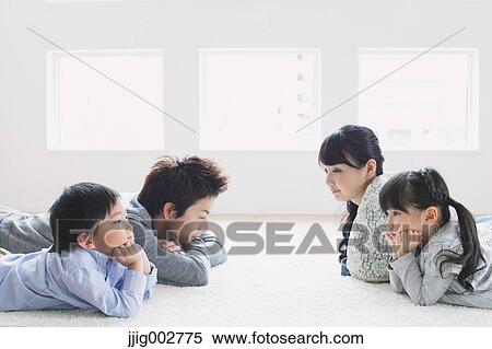 Young family laying on the floor View Large Photo Image Stock Photography - Young family laying on the floor. Fotosearch