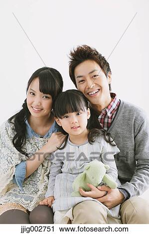 Young family relaxing on the sofa View Large Photo Image Stock Image - Young family relaxing on the sofa. Fotosearch