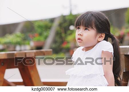 Stock Photo - Young girl looking up. Fotosearch