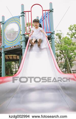 Picture - Young girl playing in the park. Fotosearch