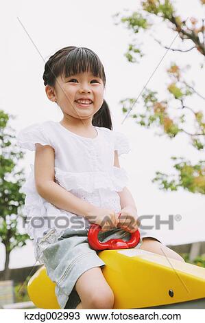 Young girl playing in the park View Large Photo Image Stock Image - Young girl playing in the park. Fotosearch