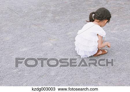 Stock Image - Young girl playing in the park. Fotosearch