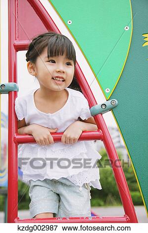 Young girl playing in the park View Large Photo Image Stock Photo - Young girl playing in the park. Fotosearch