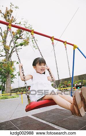 Stock Photo - Young girl playing in the park. Fotosearch