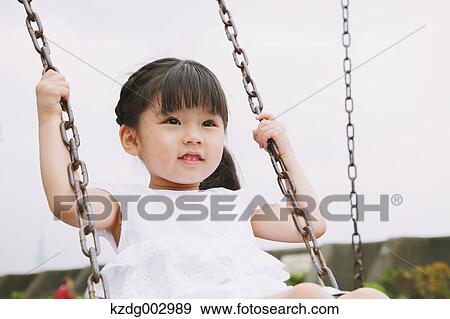 Young girl playing in the park View Large Photo Image Stock Photo - Young girl playing in the park. Fotosearch
