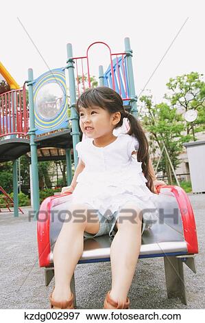 Stock Photo - Young girl playing in the park. Fotosearch