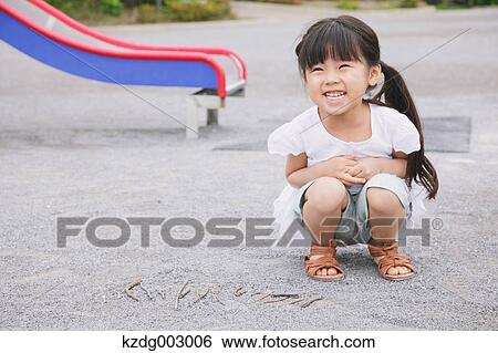 Young girl playing in the park View Large Photo Image Stock Photograph - Young girl playing in the park. Fotosearch