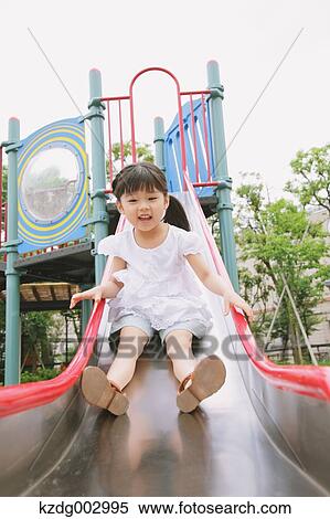 Young girl playing in the park View Large Photo Image Stock Photography - Young girl playing in the park. Fotosearch