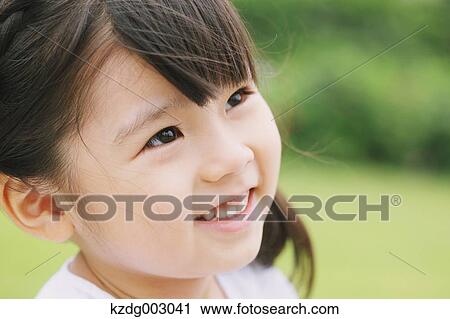 Stock Image - Young girl smiling away. Fotosearch